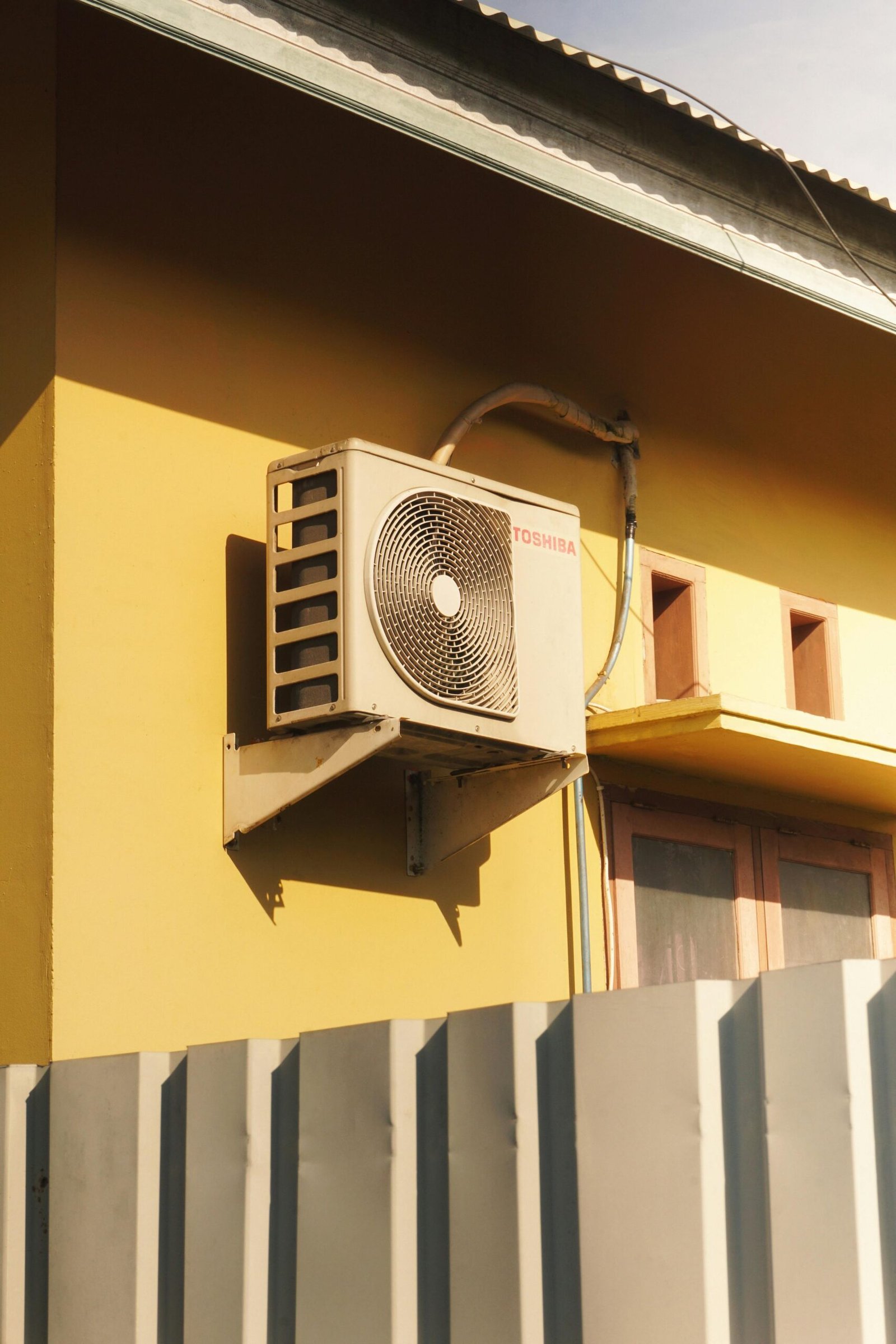 Outdoor heating and cooling equipment mounted along an exterior wall