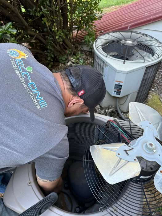 Eco-One technician repairing an outdoor air conditioner