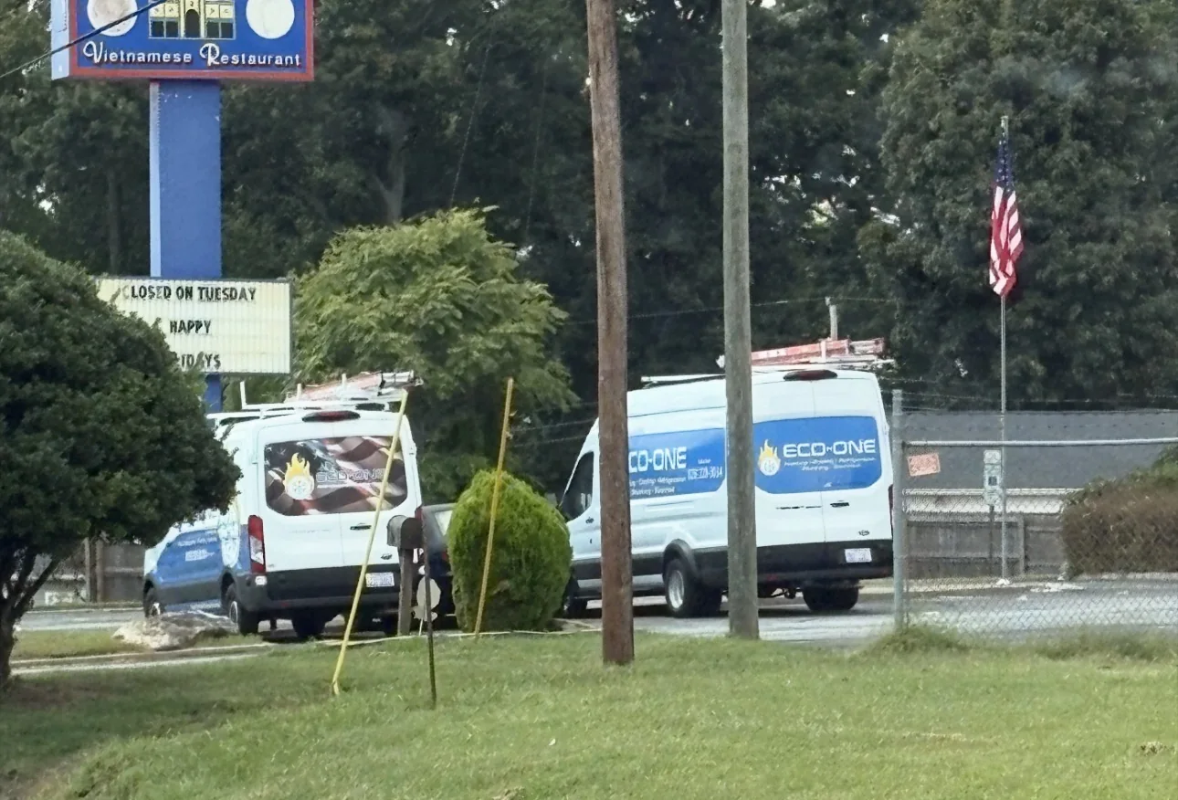 Eco-One service vans parked together near a local business