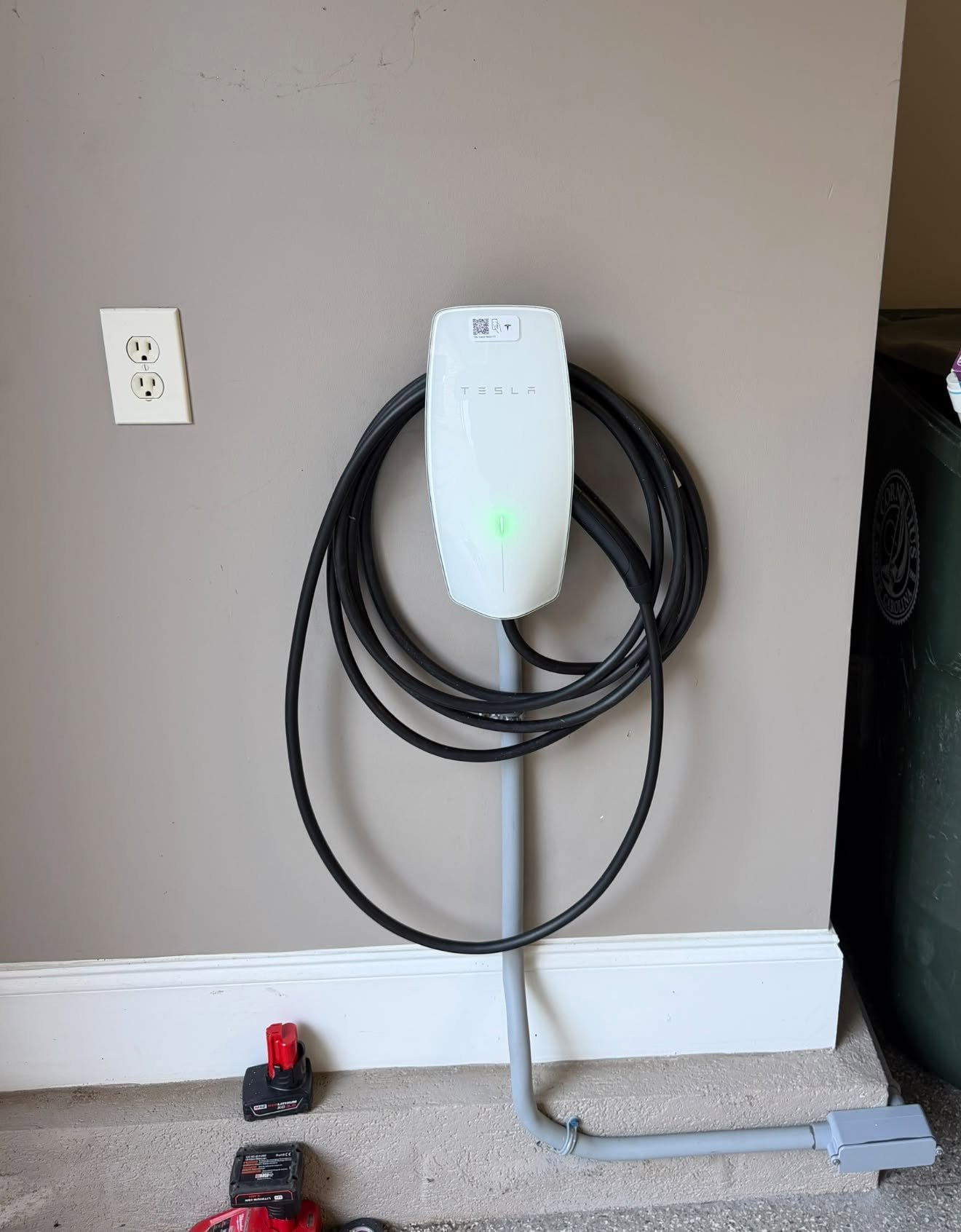 Tesla Wall Connector installed by Eco-One in a home garage