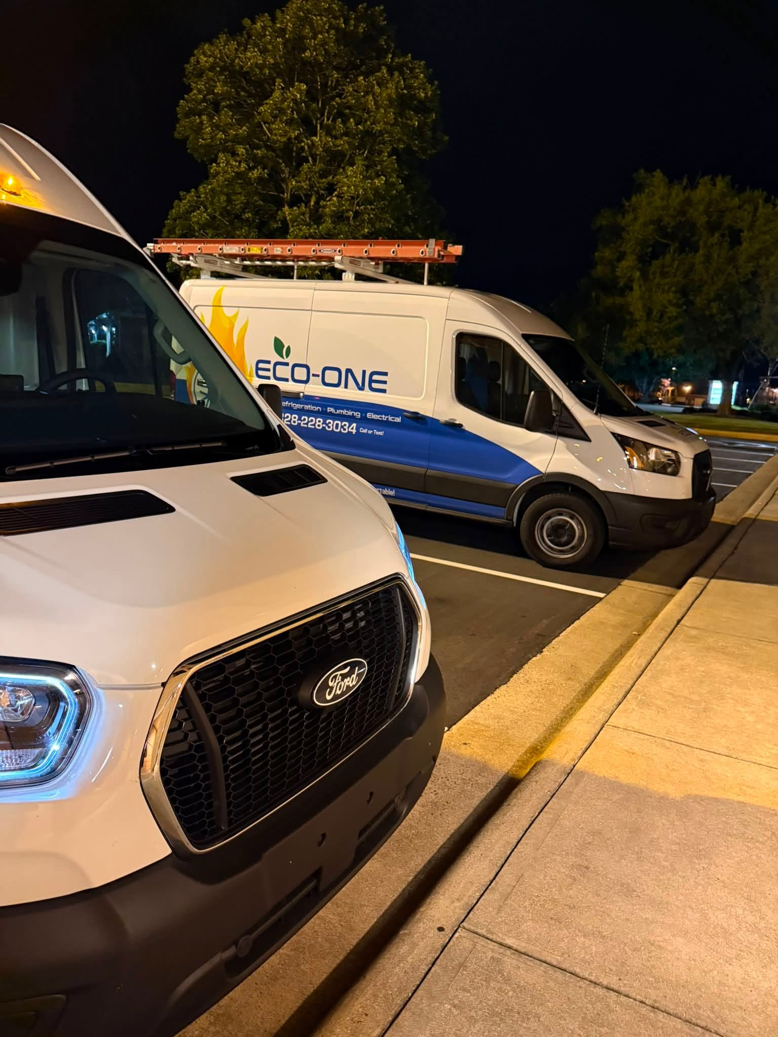 Eco-One service vans parked on an evening service call